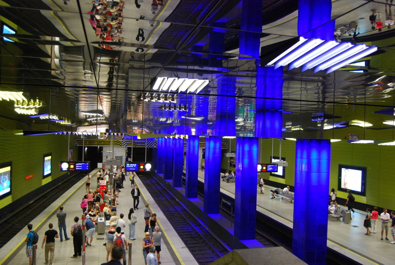 The Münchner Freiheit station on the Munich U-Bahn, featuring its distinctive blue illuminated columns and green tiled walls redesigned by lighting designer Ingo Maurer